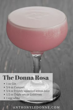 a pink drink in a coupe glass with a label on the side that says, the donna rosa