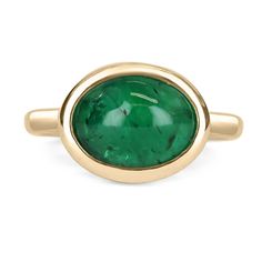 A bezel-set emerald cabochon ring in 14K yellow gold. Featured here is this lovely 4.77-carat natural, earth-mined, emerald cabochon. This stone displays a gorgeous, vivid dark green color, and very good luster. This natural beauty is set in a 14K yellow gold bezel setting. Setting Style: Bezel / Solitaire set Setting Material: 14K Yellow Gold Gold Weight: 5.3 Grams Main Stone: Emerald Cabochon Shape: Oval Cut Weight: 4.77-Carats Clarity: Translucent Color: Dark Green Luster: Very Good Origin: Z Emerald Cabochon, Emerald Gem, Emerald Rings, Dark Green Color, Solitaire Setting, Colombian Emeralds, Cabochon Ring, Pinky Ring, Unisex Jewelry