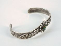 "Here's an old classic bracelet from the 1940s and The Silver Arrow Shop! What a cute little turquoise and silver vintage Fred Harvey Era bracelet. This cute bracelet has traditional stamping and two overlaid arrows. The center piece features a natural turquoise stone. This bracelet measures 4\" inches inside circumference with a 1\" inch opening for a total circumference of 5\" inches. The inside is marked, \"Sterling\" and the \"Silver Arrow\" logo. Very good vintage condition. Sweet gift for Adjustable Retro Nickel-free Jewelry, Classic Turquoise Adjustable Bracelet, Antique Turquoise Adjustable Bracelet, Antique Adjustable Turquoise Bracelet, Handmade Vintage Sterling Silver Bracelets, Retro Handmade Bangle Jewelry, Vintage Green Bracelet With Patina, Vintage Green Adjustable Cuff Bracelet, Vintage Turquoise Engraved Bracelets