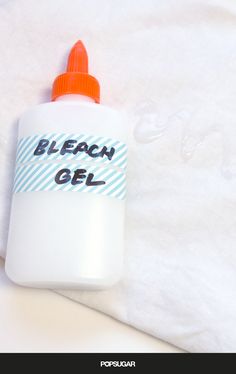 a bottle of bleach gel sitting on top of a bed