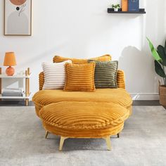 a living room with a yellow couch and pillows