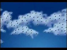 there are many clouds in the blue sky with one cloud above it and two birds flying over them