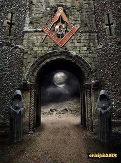 the entrance to an old castle with two statues and a masonic symbol on it's wall