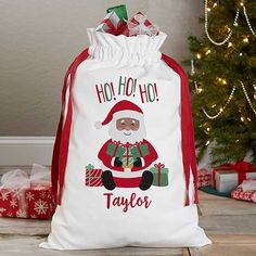 a santa clause bag sitting next to a christmas tree