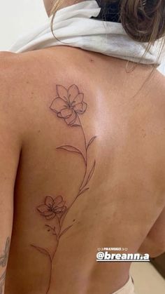 a woman with a flower tattoo on her back