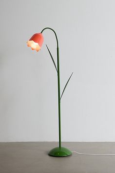 a lamp that is on top of a table next to a white wall and floor