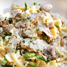 pasta with mushrooms and asparagus on a white plate