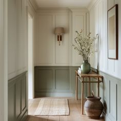 the hallway is clean and ready to be used as a place for flowers in vases