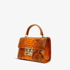 Width: 9" Height: 7" Width: 5" Strap length: 44" Queen Orange Python Leather Handbag: Radiant Elegance Exotic Python Leather: Revel in the allure of luxury with this handbag crafted from 100% genuine python leather, showcasing a distinctive texture and a touch of exotic charm. Single-Compartment Splendor: Embrace modern simplicity with a one-compartment design that radiates sophistication. Opulent Gold Chain Strap: Elevate your style with the detachable gold chain strap, offering the flexibility Murano Jewelry, Silk Kimono Jacket, Patterned Tights, Unique Bags, Business Bag, Brass Handles, Italian Luxury, Small Accessories, Luxury Outfits