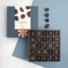 a box of chocolates next to a card with the word neuhus on it