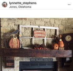 a fireplace mantle with pumpkins and other decorations on it