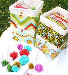 several colorful bags sitting on top of a white cloth covered ground next to each other