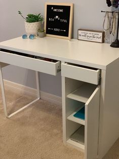 a white desk with an open drawer underneath it