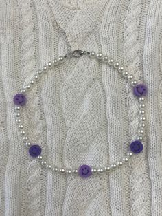 purple smiley necklace with faux pearls! There is an extender to adjust the size. This is meant to be worn as a choker. Trendy Purple Necklace With Round Beads, Trendy Purple Round Bead Necklaces, Trendy Purple Beaded Necklace For Gift, Trendy Purple Adjustable Necklace, Trendy Adjustable Purple Necklace, Trendy Purple Round Bead Necklace, Trendy Purple Beaded Necklace, Adjustable Purple Necklaces, Adjustable Purple Necklace