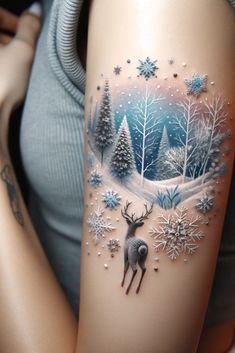 a woman's arm with a deer and snowflakes tattoo on the side