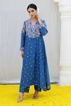 Jean blue kurta features a heavily embroidered jaal on the yoke enhanced with organza rosettes, sprinkled with dori dots all over. Paired with embroidered palazzo.
Components: 2
Pattern: Embroidered
Type Of Work: Resham
Neckline: Cutwork
Sleeve Type: Long
Fabric: Banaras Silk Base
Color: Blue
Other Details: 
Lace detail
Floral applique
Note: Kindly contact customer service for embroidered dupatta
Occasion: Mehendi and Haldi - Aza Fashions Kurta And Palazzo, Blue Kurta, Palazzo Set, Embroidered Dupatta, Fashion App, Floral Applique, Cut Work, Embroidered Silk, Set For Women