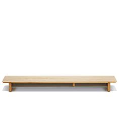 a wooden shelf sitting on top of a white wall in front of a white background