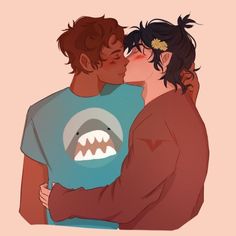 two people are hugging each other and one has a shark t - shirt on