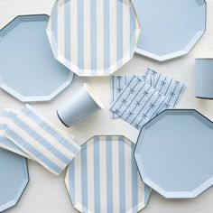 blue and white striped plates with matching napkins on the side, next to each other