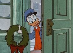 donald ducky looking in the door at another person with a wreath around his neck