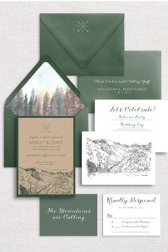 wedding stationery with mountains and trees on the front, green envelopes and matching cards