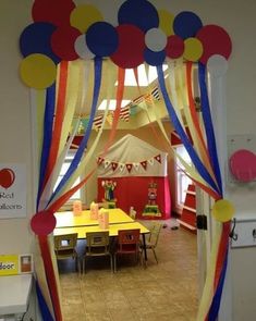 an open door with balloons and streamers hanging from it's sides in a room