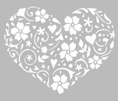 the stencil heart is shown with flowers and swirls in white on a gray background