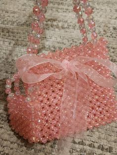 You will fall in love with this peach beaded bag. Glowing beads are used . Looks pretty in sunlight as well as in dark. It comes with a sling of 95 cm. Easy to keep mobile and small accessory.  It comes with beautiful Jute Cover with logo. Best gift for any Girl or lady. Size 15cm by 14cm . 8 Cm handles . Pink Beaded Pouch Bag, Pink Beaded Party Shoulder Bag, Pink Beaded Shoulder Bag For Party, Elegant Pink Beaded Shoulder Bag, Pink Shoulder Bag With Pearl Handle, Pink Shoulder Bag With Pearl Handle For Fashion, Summer Pink Beaded Bag, Summer Pink Beaded Shoulder Bag, Elegant Pink Shoulder Bag For Beach