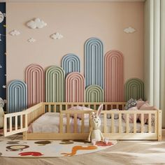 a child's room with pastel colored walls and wooden crib in the foreground