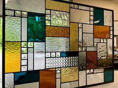 a wall with many different colored glass panels on it