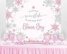 a pink and gold snowflake themed birthday party with desserts on the table