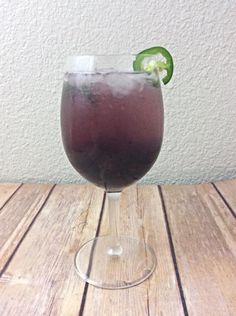 a close up of a drink on a wooden table