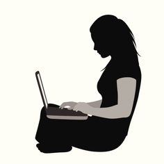 a woman sitting on the floor using a laptop computer while holding her hand in her lap