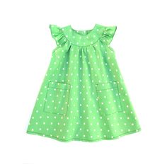 a green dress with white polka dots on it