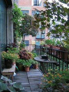 an outdoor balcony with potted plants on it