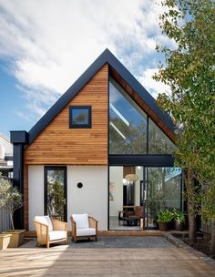 a modern house with wood and glass on the roof