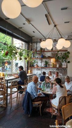 a group of people sitting around a table in a restaurant