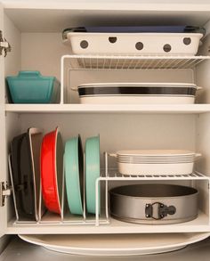 an open cabinet filled with dishes and pans