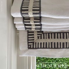 a stack of white towels sitting on top of a window sill