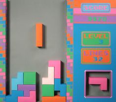 an old school arcade game with neon colored blocks and numbers on the front, side and back panels