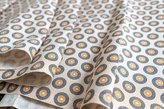 Concentric disc patterns, dots and an overall neutral tone give this shweshwe fabric its riveting appearance. The background colour is beige, with black and brown imprints. Shweshwe is an iconic and distinctive South African cotton fabric characterised by its bright colours, motifs and intricate patterns. The fabric is durable making it versatile for many uses including fashion, traditional ceremonies, quilting, light furnishings and other everyday use. Minimum order = 1m. If ordering more than one metre, your fabric will be sent as a continuous piece. About the fabric: *100% cotton *120 thread count *89-90cm width *Signature smell (will fade after washes) *Versatile use for clothing, home and textile furnishings, quilting, craft and sewing (recommended to wash before use) *Made in South A Unstitched Wedding Fabric With Traditional Patterns, Shweshwe Dresses Patterns 2020, Shweshwe Print Fabrics, Yellow Shweshwe Fabric, Green Shweshwe Material, Shweshwe Dresses Patterns, Shwe Shwe Fabric, Brown Traditional Fabric With Traditional Patterns, Seshoeshoe Dresses