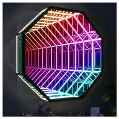 a colorful light up hexagonal mirror hanging on the wall