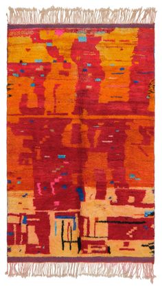 an orange, red and yellow rug with fringes on the bottom is shown in front of a white background