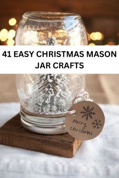 a mason jar filled with snow and christmas decorations