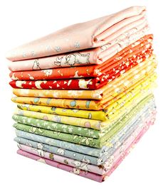 a stack of different colored fabrics on top of each other in various colors and patterns