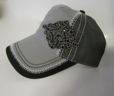 This adorable two tone grey and black trucker with white stitching is a high quality hat. I designed it with a gorgeous black rhinestone accent. Cotton Twill trucker with velcro pony tail back. See more of my hats here: http://www.etsy.com/shop/theraggedyrose?section_id=10557807 Adjustable velcro back. CUSTOM ORDERS ALWAYS WELCOME.... Will ship in 1 to 2 business days after payment is received. Thanks for taking the time to stop by and look at my little shop. Hope you enjoyed. Thanks so much. Co Cadet Hat, Rose Applique, Quality Hats, Black Rhinestone, Pink Grey, Cotton Twill, Custom Orders, Baseball Cap, Caps Hats