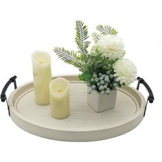 a tray with candles and flowers on it