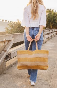 Perfect for an afternoon at the market, a day at the beach or a weekend adventure, this packable jute tote makes an ideal companion on any outing. It's handwoven in Bangladesh using traditional techniques and botanic dyes that give it an earthy, one-of-a-kind look and feel. 23"W x 14"H x 4"D Jute Spot clean Imported Spring Handwoven Beach Bag, Natural Coastal Beach Bag For Everyday Use, Woven Burlap Tote Straw Bag, Casual Summer Burlap Straw Bag, Summer Burlap Straw Bag For Everyday, Burlap Straw Bag For Beach In Summer, Summer Beach Burlap Straw Bag, Summer Fair Trade Tote Beach Bag, Summer Beach Bag In Burlap For Everyday Use