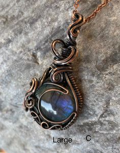 "Moonstone pendants (C and D): Grade AAA rainbow moonstone set in solid sterling silver. Small size is 1.75\", large size is 2.25\" Ships in a simple box with 18\" silver clad chain. Labradorite pendants (A and B): Grade AAA blue labradorite set in copper wire. Small size is about 1.75\" tall, large size is about 2.25\" tall. Ships with 18\" copper chain in simple box. *Please note that I am not a chain supplier, I include only very basic chains with my pendants. If you love the piece I would re Moon Wire Wrap, Wire Wrapped Moon, Wire Wrapped Stone Jewelry, Wire Wrap Jewelry Designs, Wire Wrapped Jewelry Diy, Bijoux Fil Aluminium, Wire Wrap Pendant, Wire Jewelry Designs, Wire Wrapping Stones