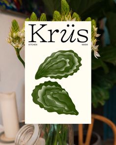 a vase with some flowers in it and the cover of k iris's magazine